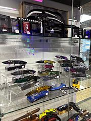 Glass display case with rows of collectible pocket knives