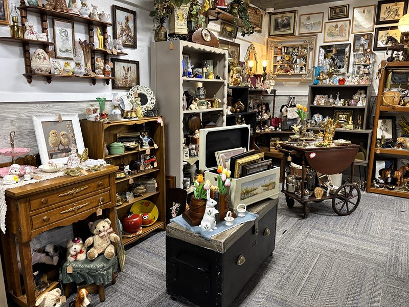 Vintage furniture with a wooden dresser, teddy bears, framed pictures and a tea cart