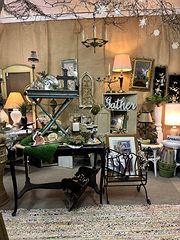 Rustic decor room with lamps, an X-base table and a Father sign on burlap walls