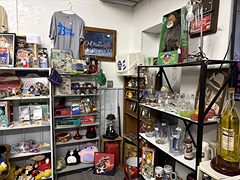 Shelves of vintage toys, plush animals and collectible glasses, with a boxed Bigfoot figure on top
