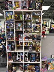 White cubby shelf filled with boxed action figures and collectible figurines