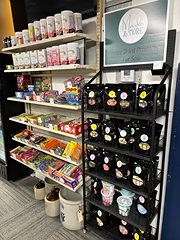 Shelves of candy and a black rack of bagged freeze-dried treats