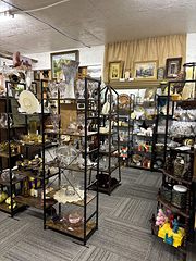 Tall metal shelves of glassware and home decor