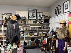 Vintage fashion booth with mannequins in a fur stole and a coat, plus hats and purses