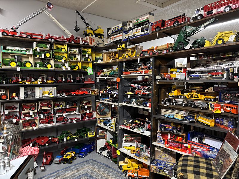 Wall-to-wall shelves of die-cast toy trucks, tractors and fire engines