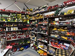 Wall-to-wall shelves of die-cast toy trucks, tractors and fire engines